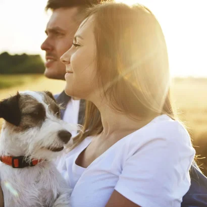 Young couple and their dog enjoying a view together after a full recovery